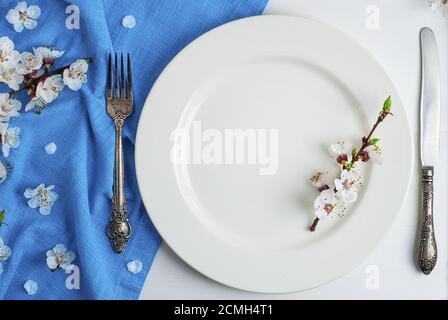 Empty white ceramic plate with iron vintage cutlery Stock Photo