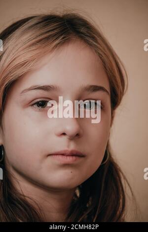 Portrait of little girl crying with tears rolling down her cheeks. Girl crying. Girl 9 years old is very upset. Teenage Stock Photo