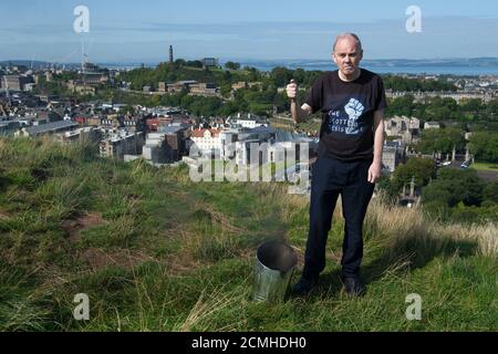 Edinburgh, Scotland, UK. 17 September 2020. Pictured: Sean Clerkin of Action For Scotland seen above the Scottish Parliament at Holyrood, Edinburgh, and burns the Union Jack Flag in a defiant act fighting for Scottish independence. Credit: Colin Fisher/Alamy Live News. Stock Photo