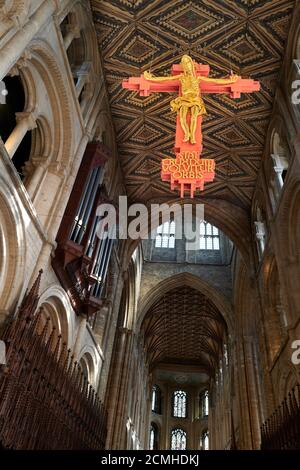 The twentieth century hanging cross of Jesus Christ crucified in the nave of the medieval built cathedral at Peterborough, England. Stock Photo