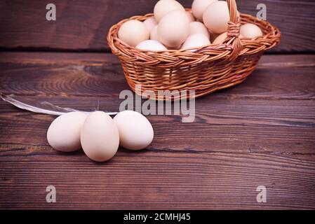 Chicken eggs in shell and in a wicker basket Stock Photo