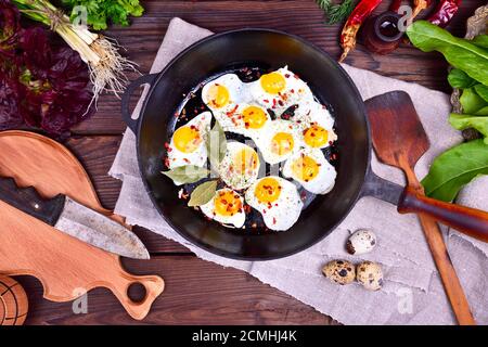 Fried quail eggs in a frying pan Stock Photo