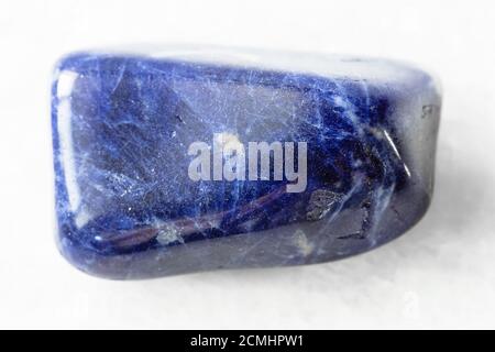closeup of sample of natural mineral from geological collection - polished Sodalite rock on white marble background from Brazil Stock Photo