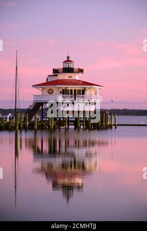 Early morning light on small harbor in Cambridge Maryland, with reflections of the peers Choptank River Lighthouse in the water. Stock Photo