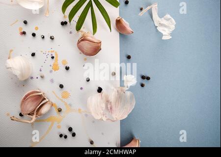 Garlic cloves on a beautiful watercolor background of white and blue. Stock Photo