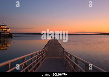 Early morning view of Harbor with Choptank River Lighthouse on the side, looking down pier Stock Photo