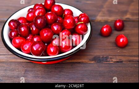 Ripe red cherry in an iron bowl Stock Photo