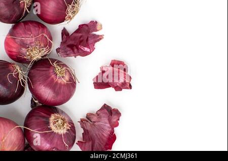 Red onion and peel close-up on a white background. Stock Photo