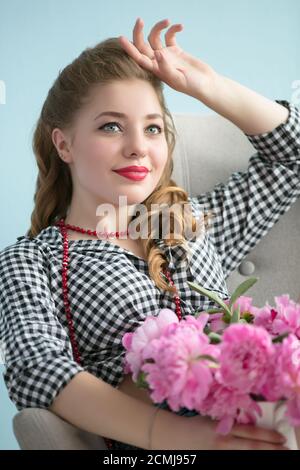 Beautiful retro girl with a bouquet of flowers Stock Photo