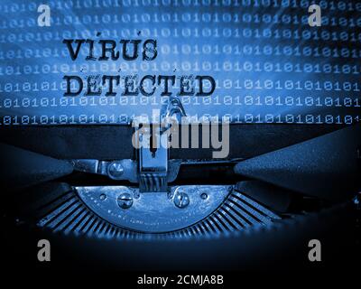 Vintage Typewriter with Virus detected typed on a page of binary numbers Stock Photo