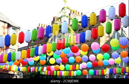 Huge colourful display of lanterns above London's Chinatown.Chinatown London in partnership with the London Chinatown Chinese Association (LCCA) has replaced the area's iconic red lanterns with thousands of special rainbow coloured lanterns. The rows of vibrantly coloured lanterns throughout the streets of Chinatown are part of the #LoveChinatown campaign, to support the community of Chinatown businesses and safely welcome people back to the area. The rainbow has also been a symbol of support throughout the pandemic to the UK's wonderful key workers. Stock Photo