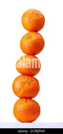 Stacked oranges in a studio setting, isolated on white. Stock Photo