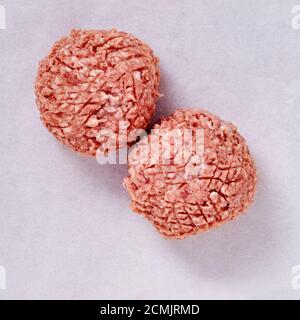 topshot of Raw meatballs in a studio setting, isolated on white. Stock Photo