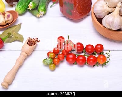cherry tomatoes and spoon with spices Stock Photo