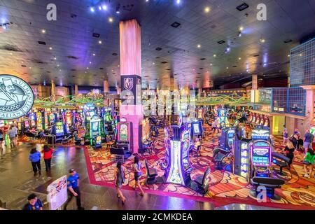 LAS VEGAS, NV - JUNE 27, 2019: Interior of Casino modern structure with people playing at slot machines. Stock Photo