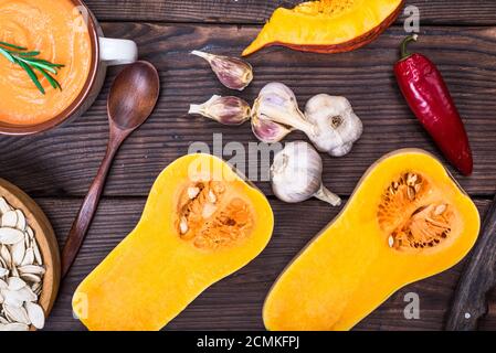 fresh pumpkin cut in half and pumpkin soup Stock Photo