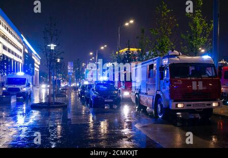 May 15, 2019, Moscow, Russia. Fire engines in the courtyard of the apartment building where the fire occurred, at night during the rain. Stock Photo