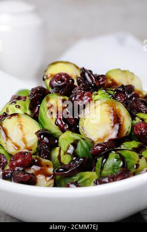 Salad from Brussels sprouts with dried cranberries under balsamic sauce Stock Photo