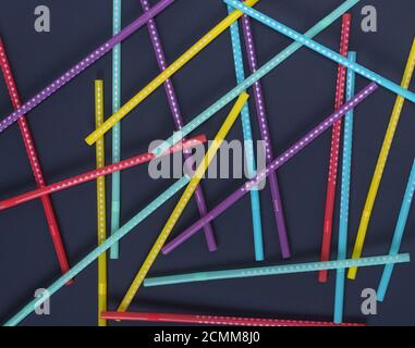 multi-colored plastic tubes in a white polka-dot for drinks Stock Photo