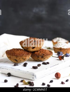 baked cupcakes with raisins on a white wooden board Stock Photo
