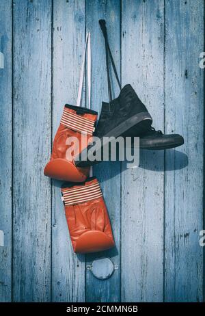 Black textile worn sneakers and red leather boxing gloves Stock Photo