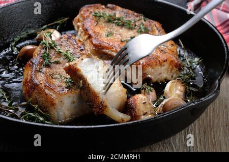 Roasted pork steak in frying pan Stock Photo