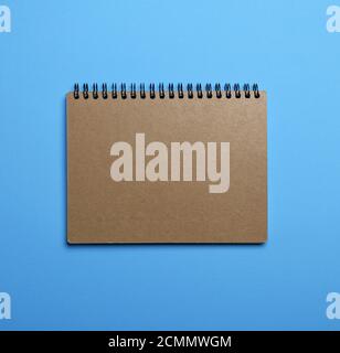notebook on a black iron spring with brown empty sheets Stock Photo