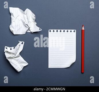 white blank sheets in a line from a notepad and red wooden pencil Stock Photo