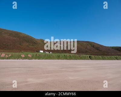 The old Rectory an islolated house in the landscape and beach at Rhossili Beach on the Gower Peninsula Wales UK Stock Photo