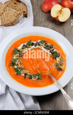 A wipe of pumpkin-apple soup with a tender, soft consistence,  yoghurt  and seasoned with pumpkin se Stock Photo