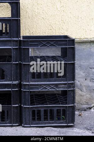 stack of empty black plastic crates Stock Photo