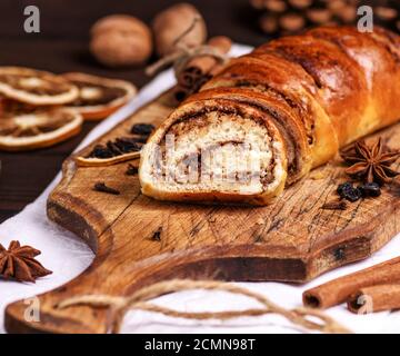 baked roll with cinnamon and nuts Stock Photo