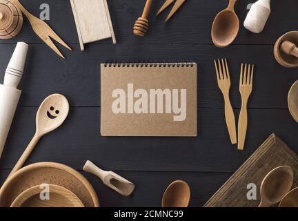 open empty paper notebook with white sheets in a line on a spring in the middle of wooden kitchen it Stock Photo