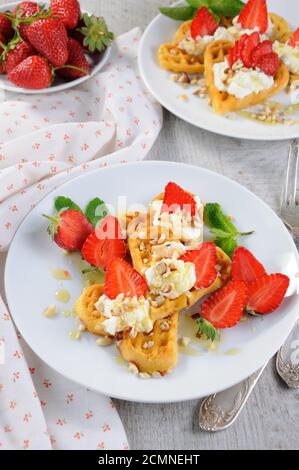 Delicate, melting  mouth-watering  Belgian waffles with whipped cream, strawberries, flavored with p
