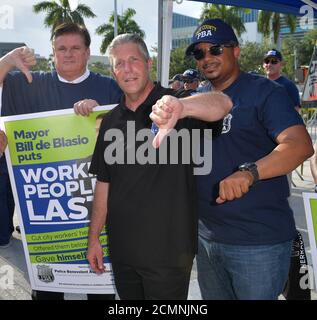 MIAMI, FLORIDA - JUNE 26: Protests outside prior to the first 2020 Democratic presidential debate including New York police officers that are protesting New York Mayor Bill de Blasio. A field of 20 Democratic presidential candidates was split into two groups of 10 for the first debate of the 2020 election, taking place over two nights at Knight Concert Hall of the Adrienne Arsht Center for the Performing Arts of Miami-Dade County on June 26, 2019 in Miami, Florida   People:  Atmosphere Stock Photo