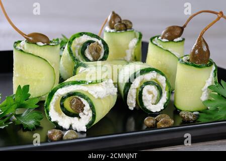 Cucumber rolls with ricotta filling and capers.   These rolls with the size of a bite -is a great op Stock Photo
