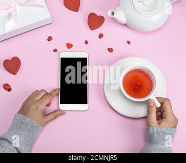 left female hand holds a smartphone with a blank black screen Stock Photo