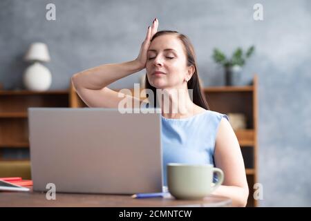 Woman training neck muscles resting taking a break from work. Stock Photo