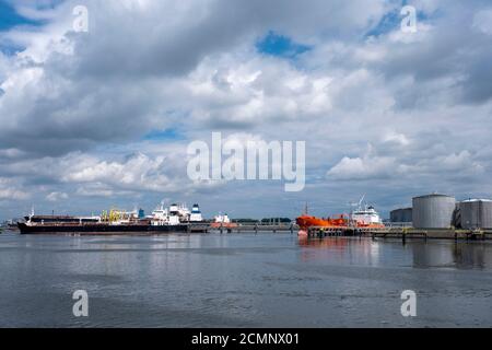Tanker and oil storage tanks in Rotterdam, Netherlands. The port is the largest in Europe and facilitate the needs of a hinterland