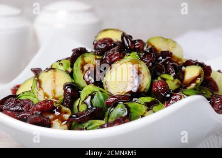 Salad from Brussels sprouts with dried cranberries under balsamic sauce Stock Photo