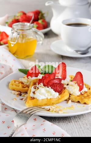 Delicate, melting  mouth-watering  Belgian waffles with whipped cream, strawberries, flavored with p