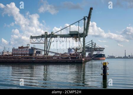 Logistics and transportation of Container Cargo ship and Cargo plane with working crane bridge in shipyard Stock Photo