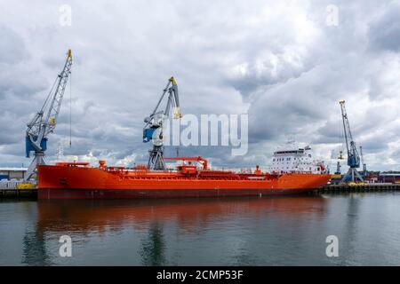 Logistics and transportation of Container Cargo ship and Cargo plane with working crane bridge in shipyard Stock Photo