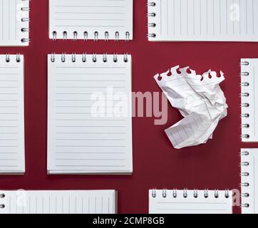 abstract red background with many notebooks with blank sheets in line Stock Photo