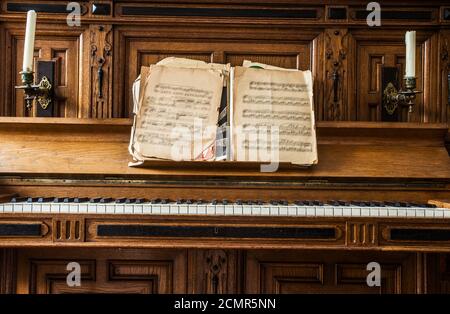 Old wooden piano keys on wooden musical instrument in front view, antique fashioned Stock Photo