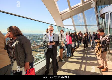 The Sky Garden is situated 35 floors up in the walkie Talkie Building.  Tourists enjoying the view from the viewing gallery,  London, 2017 Stock Photo