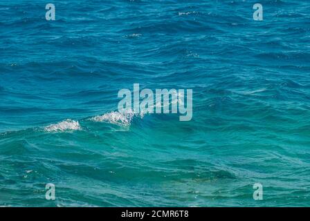 Wide shot of a beautiful clear turquoise sea ocean water surface with low ripples and subtle waves on seascape background, horiz Stock Photo