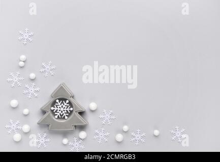 Christmas or new year composition. Snowflakes and decorative spruse on gray background. Holiday and celebration concept for postcard or invitation. To Stock Photo