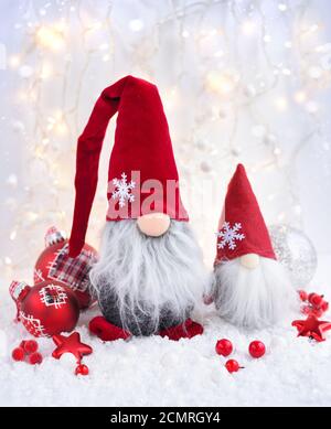 Christmas decorations cute figure gnomes with festive decorations оn the snow. Christmas or New Year greeting card. Stock Photo