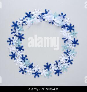 Christmas or new year composition. Round frame made of snowflakes on gray background. Top view Stock Photo